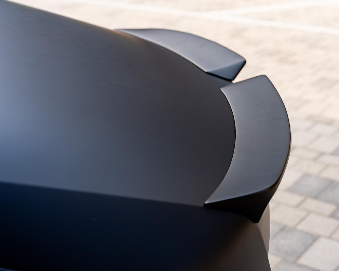 Matte carbon coachwork detail, raking light