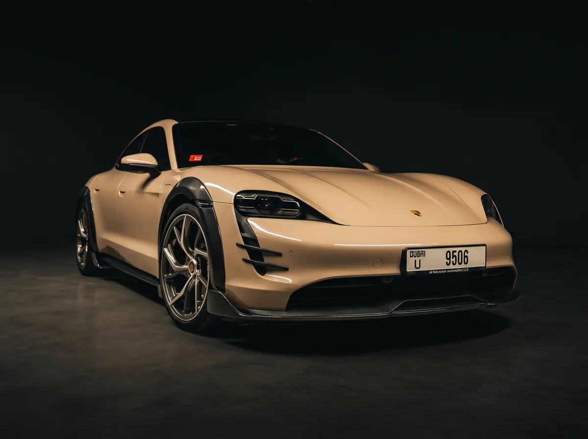 Porsche Taycan, front three-quarter, carbon arches and splitter
